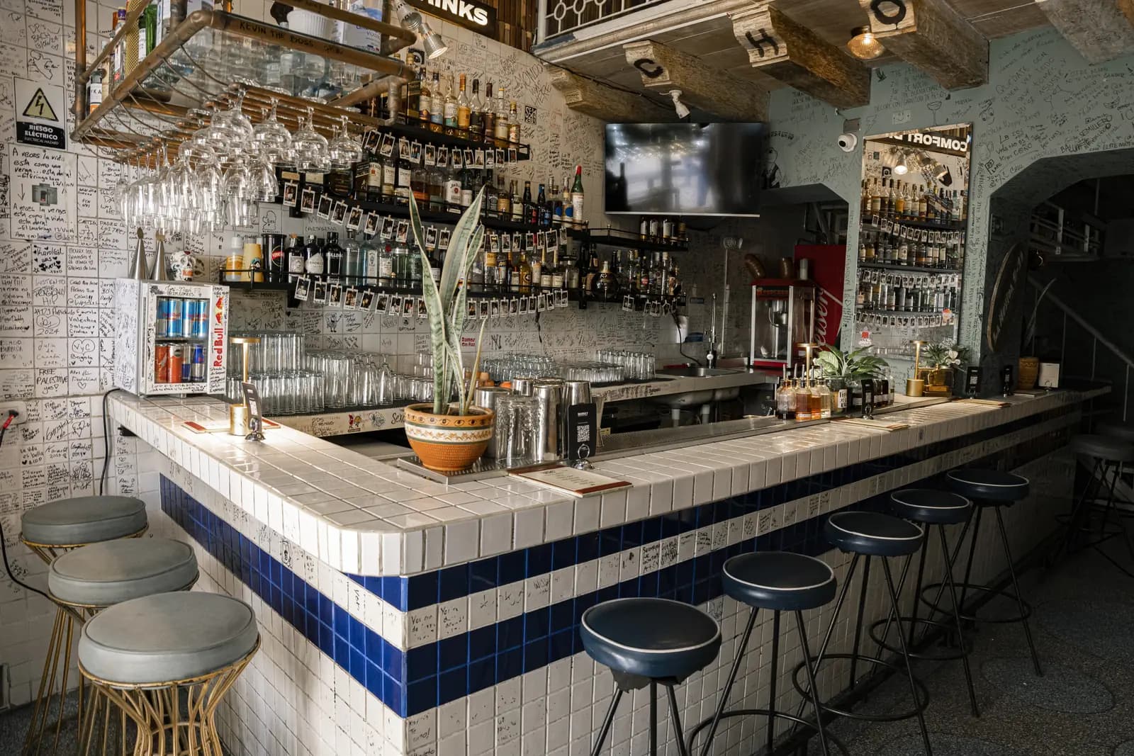 La barra de baldosa blanca con la pared de botellas